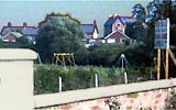 a 60s/70 zoom-in of the Playnies. You can just see the witch's hat and the yellow two-seater swings